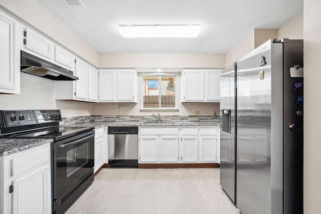 kitchen with under cabinet range hood, appliances with stainless steel finishes, white cabinets, and light stone counters