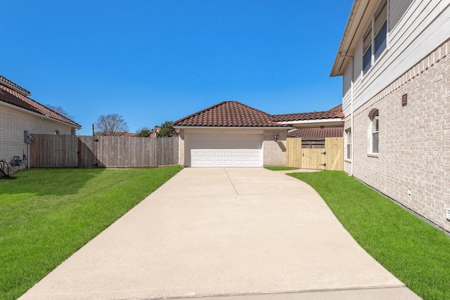 view of yard featuring a garage, a gate, and fence