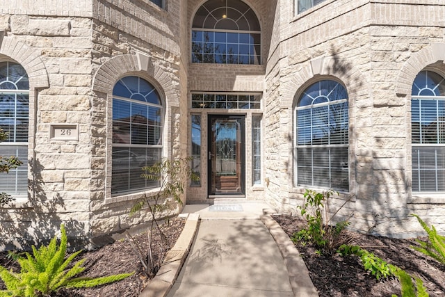 property entrance featuring stone siding
