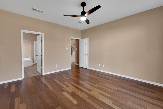 unfurnished bedroom with ceiling fan, wood finished floors, visible vents, and baseboards