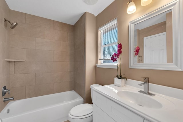 bathroom with bathtub / shower combination, vanity, and toilet