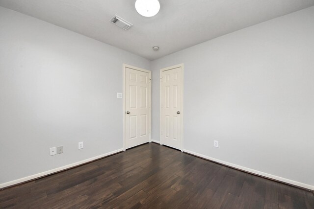 10138 W Palm Lake Dr, Houston, TX 77034 - empty room with baseboards, visible vents, and dark wood finished floors