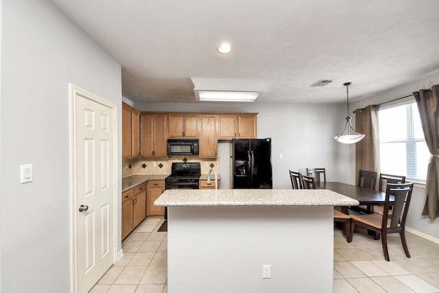 10138 W Palm Lake Dr, Houston, TX 77034 - kitchen with visible vents, a kitchen island, black appliances, backsplash, and light tile patterned flooring