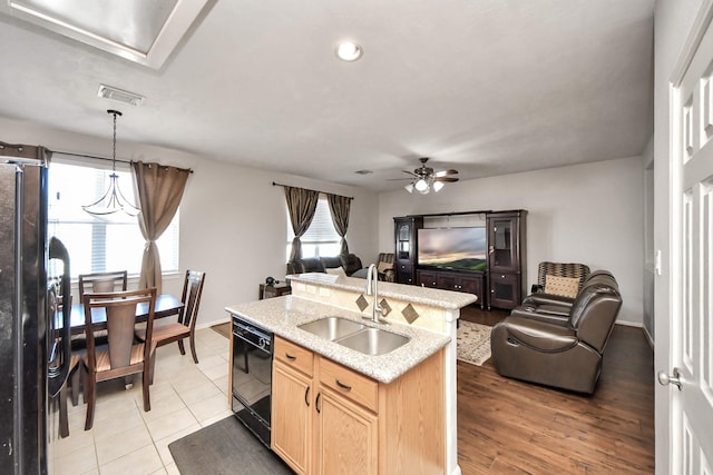 10138 W Palm Lake Dr, Houston, TX 77034 - kitchen featuring visible vents, light brown cabinetry, open floor plan, a sink, and black appliances