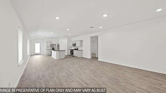 unfurnished living room featuring light wood-type flooring, baseboards, lofted ceiling, and recessed lighting