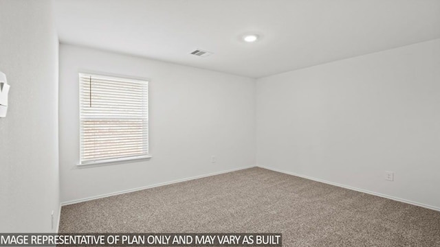 carpeted spare room featuring visible vents and baseboards