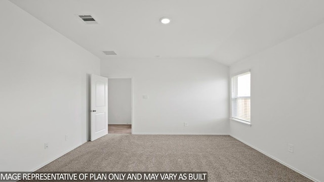 carpeted spare room featuring baseboards, visible vents, and vaulted ceiling