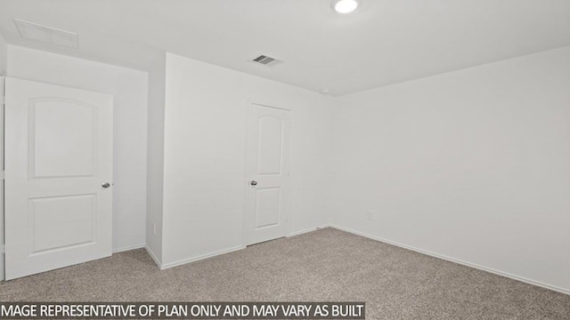 carpeted spare room featuring visible vents and baseboards