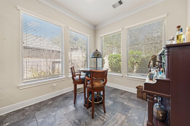 dining area featuring visible vents, stone finish flooring, baseboards, and ornamental molding