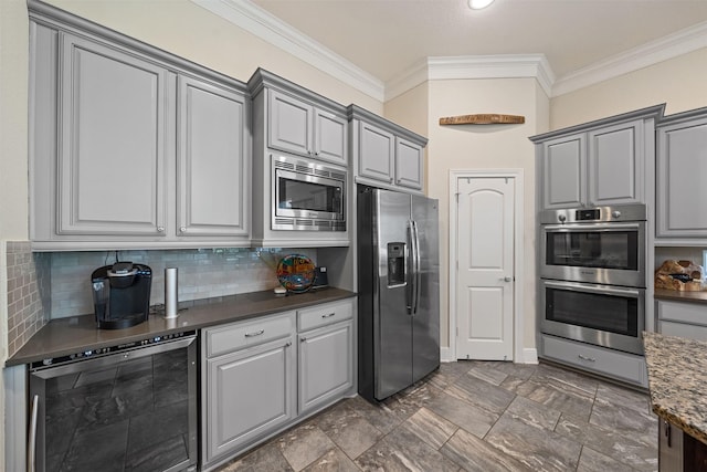 kitchen featuring gray cabinetry, tasteful backsplash, stainless steel appliances, wine cooler, and crown molding