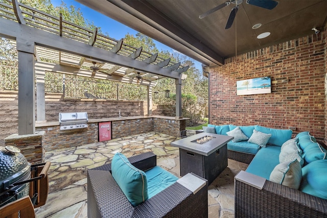 view of patio / terrace with an outdoor kitchen, area for grilling, a pergola, ceiling fan, and an outdoor living space with a fire pit