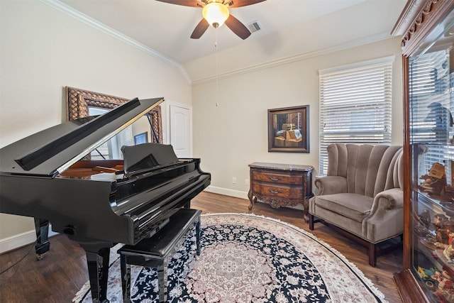 sitting room with wood finished floors, baseboards, visible vents, vaulted ceiling, and crown molding