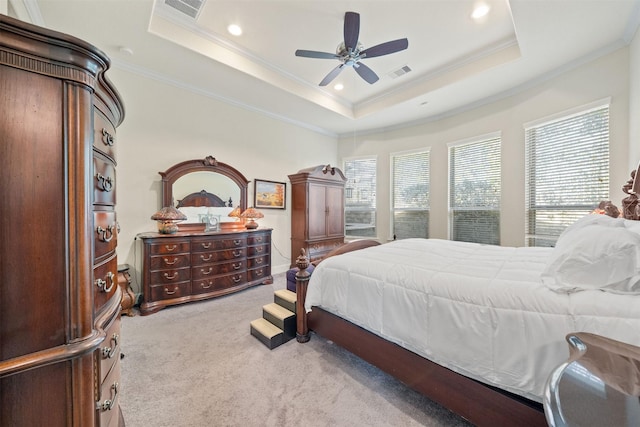 carpeted bedroom featuring visible vents, a raised ceiling, and ornamental molding