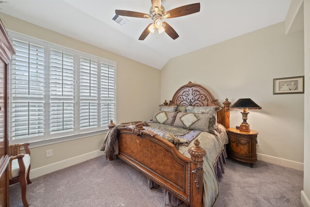 carpeted bedroom featuring visible vents, baseboards, ceiling fan, and vaulted ceiling