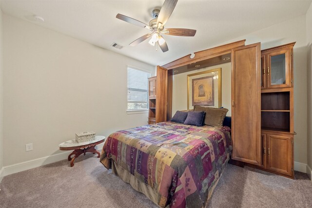 bedroom with visible vents, carpet floors, baseboards, and a ceiling fan