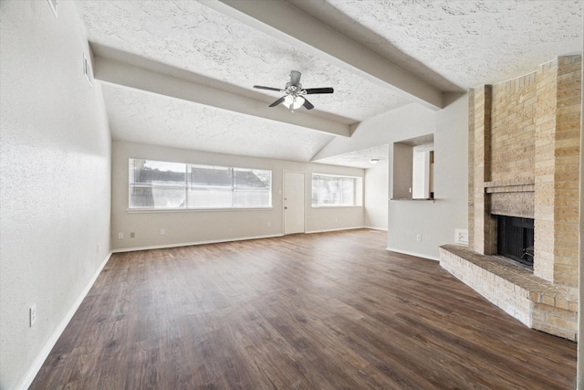 unfurnished living room with a fireplace, dark wood-type flooring, a ceiling fan, a textured ceiling, and baseboards