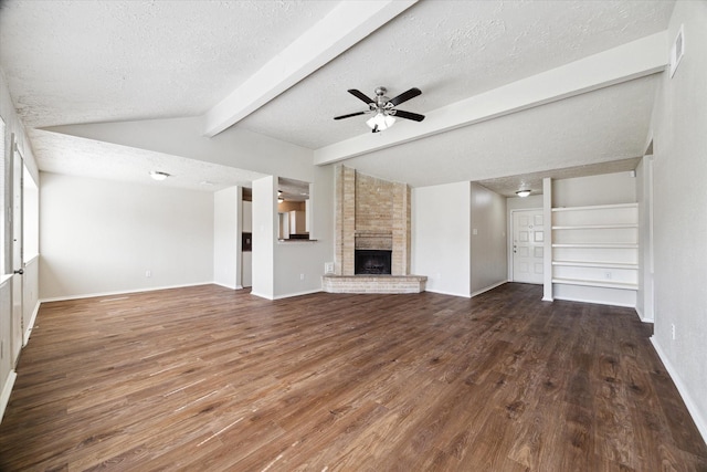 unfurnished living room with vaulted ceiling with beams, a fireplace, ceiling fan, a textured ceiling, and wood finished floors