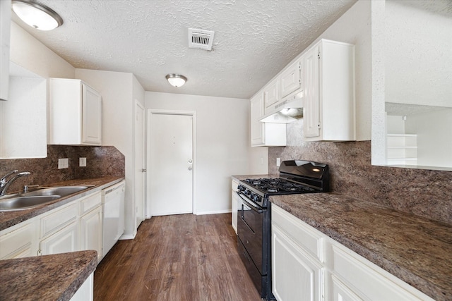 kitchen with dishwasher, dark countertops, dark wood-type flooring, black gas stove, and under cabinet range hood