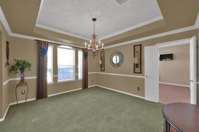 carpeted dining area featuring a tray ceiling, baseboards, and ornamental molding