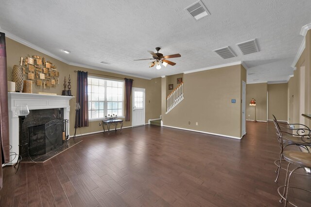 unfurnished living room featuring wood finished floors, visible vents, and a high end fireplace