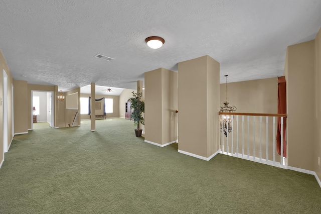 interior space with an inviting chandelier, carpet, visible vents, and baseboards