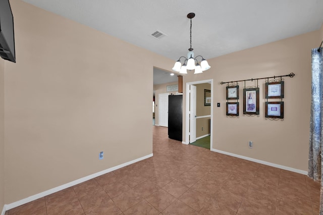 empty room featuring a notable chandelier, baseboards, visible vents, and light tile patterned floors