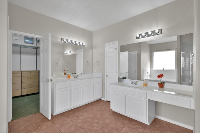 full bathroom with tile patterned flooring, a shower stall, two vanities, and a sink