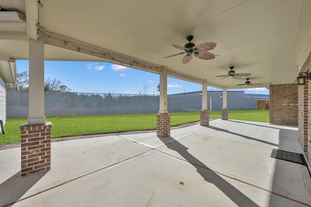 view of patio with a fenced backyard and a ceiling fan