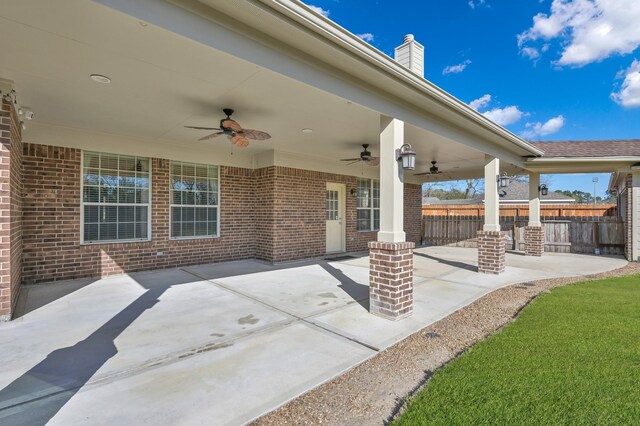 view of patio with a ceiling fan and fence