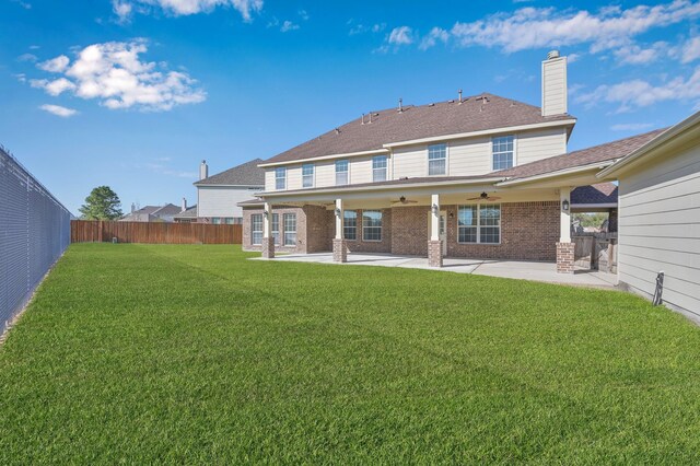 back of house with a patio area, a ceiling fan, a lawn, and a fenced backyard