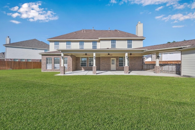 rear view of house with a patio area, fence, a lawn, and ceiling fan