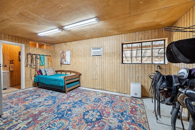 carpeted bedroom featuring wooden walls and a wall mounted AC