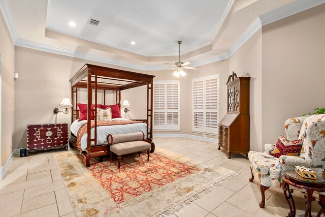 bedroom with tile patterned flooring, a tray ceiling, crown molding, and baseboards