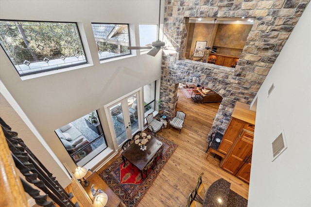 living room featuring a high ceiling, wood finished floors, and a ceiling fan