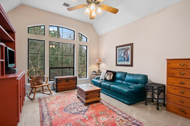 living room featuring lofted ceiling, light colored carpet, visible vents, and ceiling fan