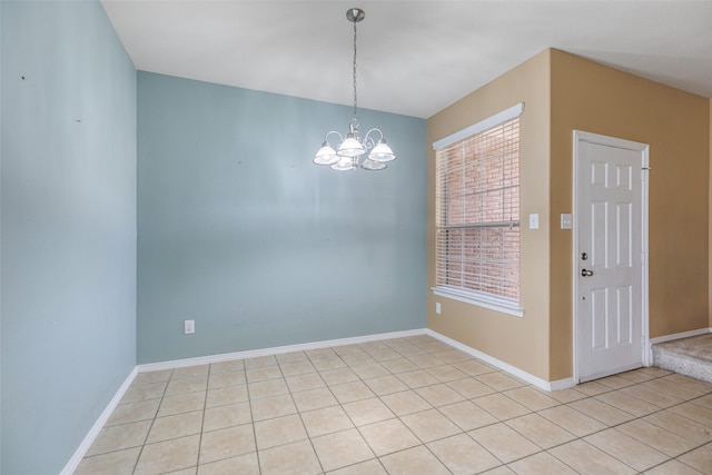 unfurnished dining area featuring light tile patterned floors, baseboards, and a chandelier