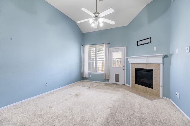 unfurnished living room with carpet, baseboards, high vaulted ceiling, ceiling fan, and a tiled fireplace