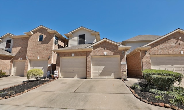 view of front of house with a garage, brick siding, and concrete driveway