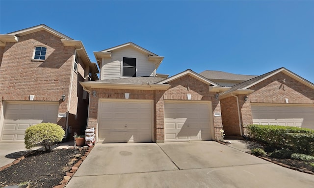 view of front of home featuring brick siding, roof with shingles, and concrete driveway