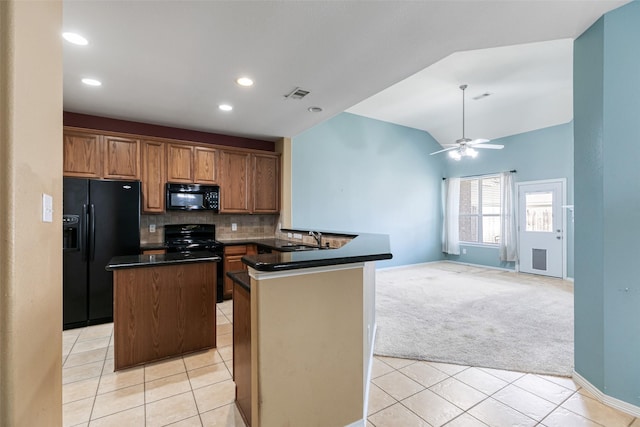 kitchen featuring dark countertops, visible vents, backsplash, light colored carpet, and black appliances