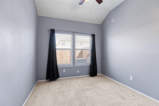 unfurnished room featuring lofted ceiling, baseboards, and ceiling fan