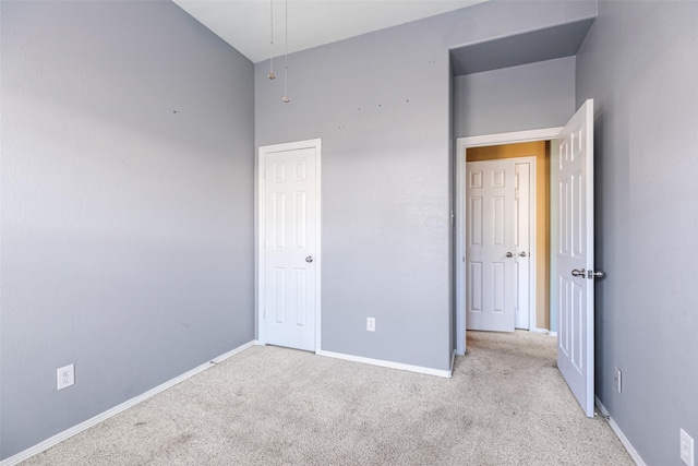 unfurnished bedroom with carpet flooring and baseboards