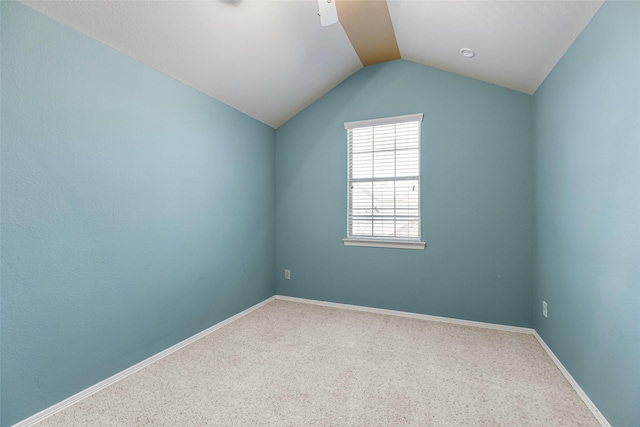 unfurnished room with baseboards and lofted ceiling