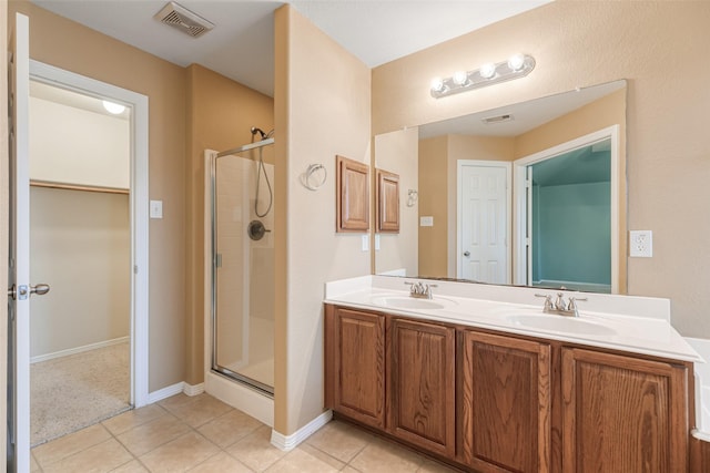 full bath with a sink, visible vents, and a shower stall