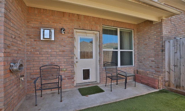 entrance to property with brick siding