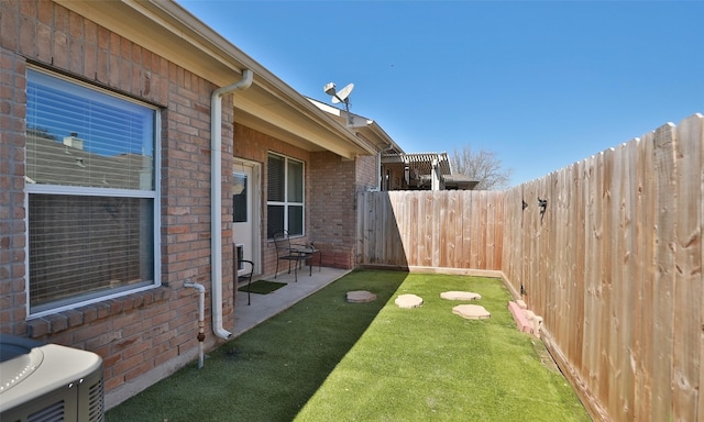 view of yard with a patio area and a fenced backyard