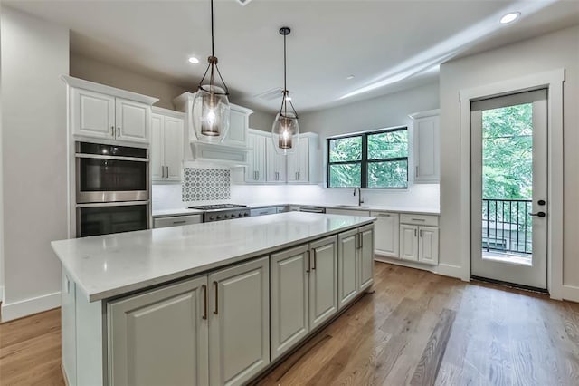 kitchen with white cabinets, stainless steel appliances, and a sink