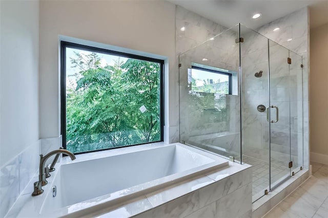 bathroom featuring a shower stall, a bath, and recessed lighting