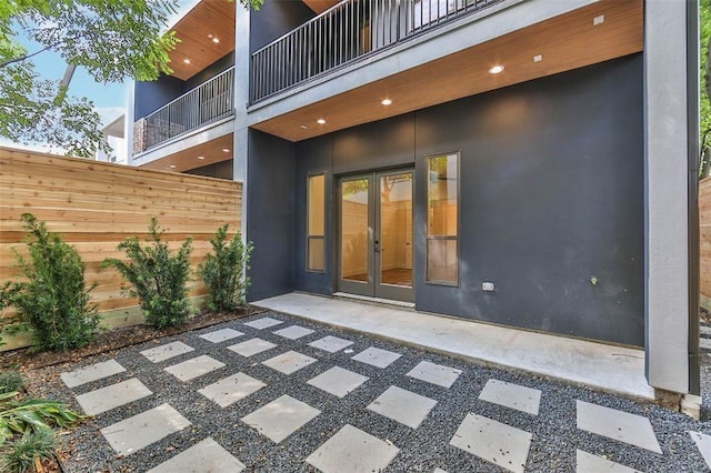 view of patio / terrace featuring french doors and fence