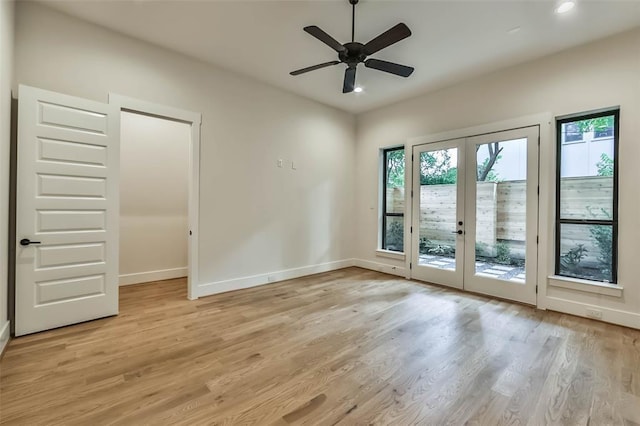 unfurnished room with light wood-type flooring, recessed lighting, baseboards, and french doors